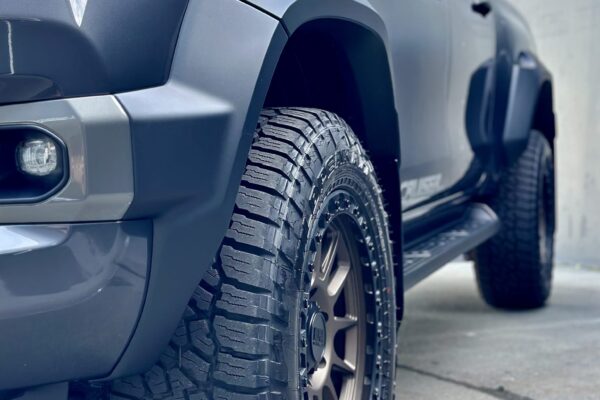 Close-up of high-quality tyres on a Toyota Hilux for 4WD rental in Christchurch, NZ